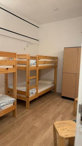 a room with three bunk beds and a table at bcool in Bilbao