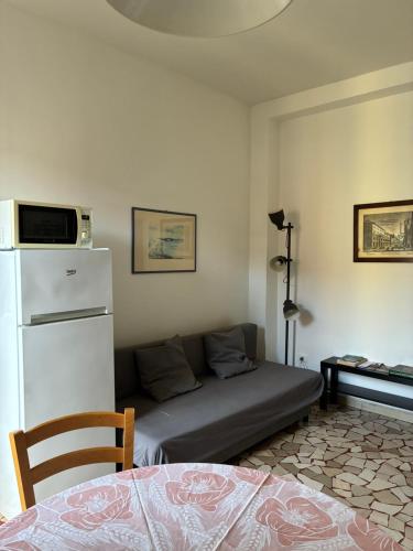 a living room with a couch and a refrigerator at Alfano Apartment in Bologna