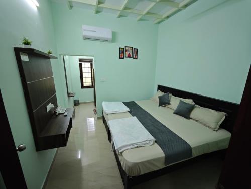 a bedroom with a large bed in a room at Angel Homestay Paravoor in Alleppey