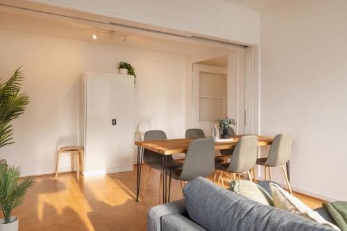 a living room with a wooden table and chairs at Spacious City View Apartment - Prime Location Biel in Biel