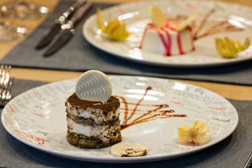 a piece of cake on a plate on a table at Wind of Lara Hotel & SPA - All Inclusive in Lara