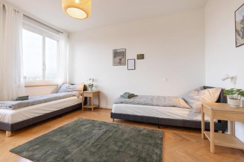 a living room with two beds and a table at Spacious City View Apartment - Prime Location Biel in Biel