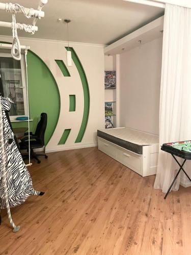 a room with a bed and a large sign on the wall at Dostyk Home in Zhezdi