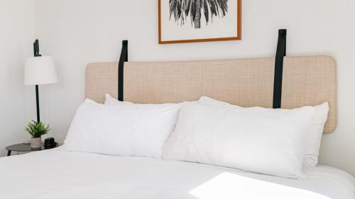 a bedroom with a bed with white pillows at 2 Coastal Studios at Cayucus Beach Access Ocean Views in Cayucos