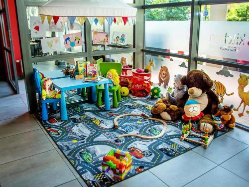 a room with stuffed animals and toys on the floor at Ibis Poznan Stare Miasto in Poznań