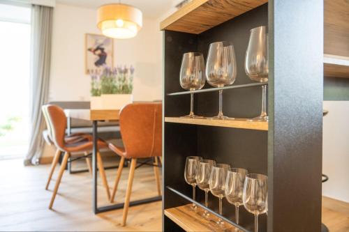 a room with wine glasses on a shelf at Panorama Spa Lodges DAS.SCHILLER in Bad Gastein