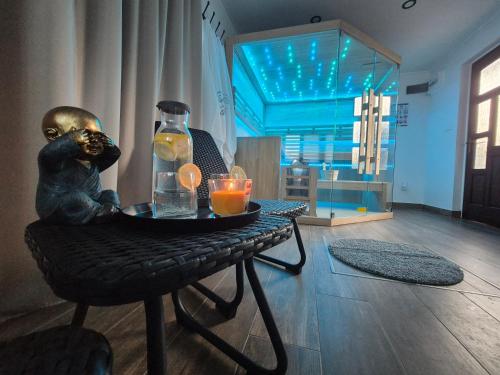 a table with a statue of a bear sitting on a chair at Apartmani Lara Modruš-Kuća za odmor in Modruš