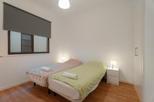 a bedroom with a bed with two pillows on it at Casa Grande in Santa Cruz de Tenerife