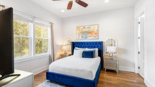 a bedroom with a blue bed and two windows at Seacrest Paradise by AvantStay Steps to the Beach Pet Friendly in Destin