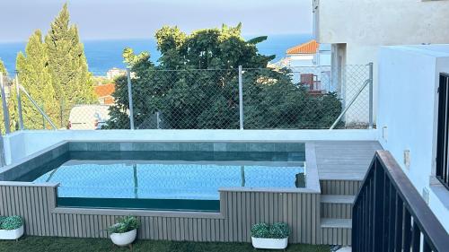 a swimming pool on the balcony of a house at SUNLIGHT Spain in Manilva