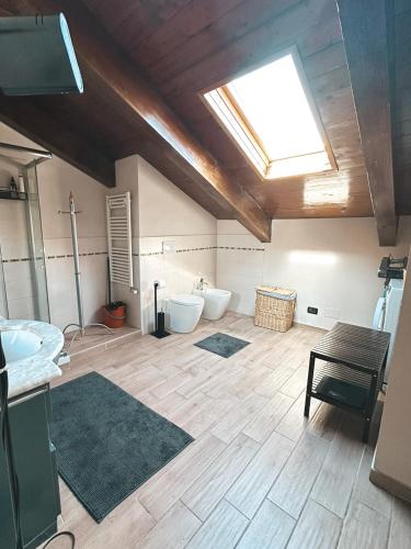 a bathroom with two toilets and a skylight at Casa Chiara - 2-bedroom apartment in Turin