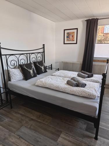 a bedroom with a large bed with pillows on it at Appartement Schöne Schwarzwald Auszeit in Friedenweiler
