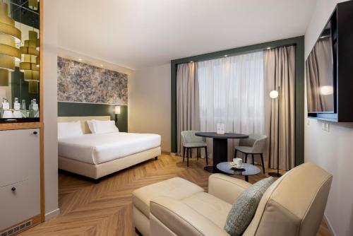 a hotel room with a bed and a table at Crowne Plaza Padova by IHG in Padova