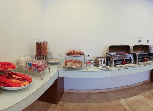 a buffet with many plates of food on a counter at One Coatzacoalcos Forum in Coatzacoalcos