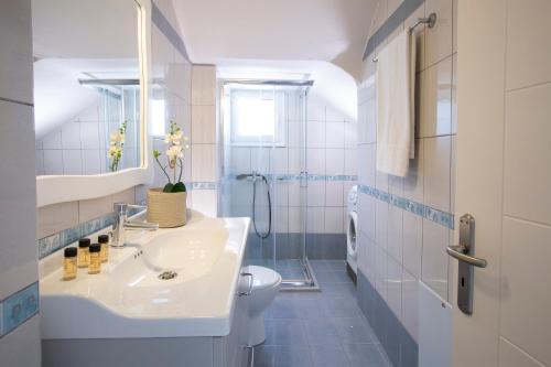 a bathroom with a sink and a toilet at Levanda Cozy Apartments in Lefkada