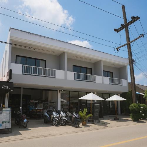 a building with motorcycles parked in front of it at Anattaya Holiday Home in Ko Yao Noi