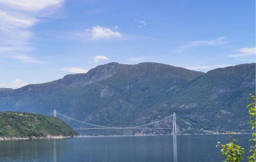 a bridge over a body of water with mountains at Awesome Home In Eidfjord With House Sea View in Bu