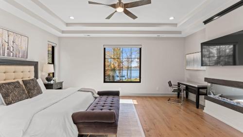 a bedroom with a large bed and a desk at The Grand on Greenbay-7 bedrooms Sleeps 20 Modern new build in Mooresville