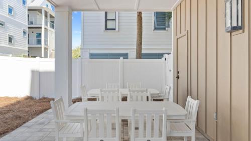 a white table and chairs on a patio at Grayt Digs by AvantStay Next to Beach Oceanview in Santa Rosa Beach