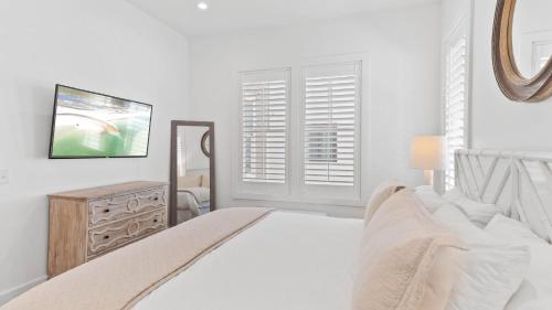 a white bedroom with a bed and a window at Grayt Digs by AvantStay Next to Beach Oceanview in Santa Rosa Beach