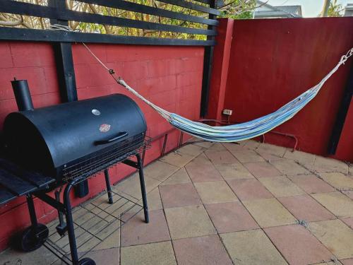 a hammock with a bbq and a grill at Beautiful Holiday Home in Gold Coast