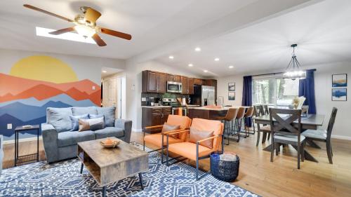a living room with a couch and a table at Moshannon Tree-Lined Pocono Retreat w Hot Tub Firepit Pool Table in Pocono Lake