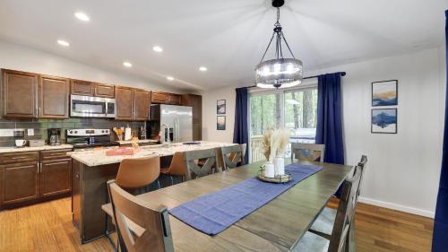 a kitchen and dining room with a table and chairs at Moshannon Tree-Lined Pocono Retreat w Hot Tub Firepit Pool Table in Pocono Lake