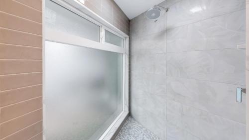 a shower with a glass door in a bathroom at California Dreamin by AvantStay Private Pool Fire Pit Near the Beach in Carlsbad