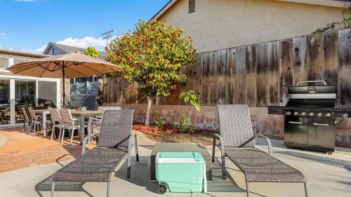 a patio with a table and chairs and a grill at California Dreamin by AvantStay Private Pool Fire Pit Near the Beach in Carlsbad