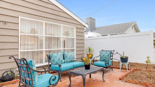 a patio with two chairs and a table at California Dreamin by AvantStay Private Pool Fire Pit Near the Beach in Carlsbad
