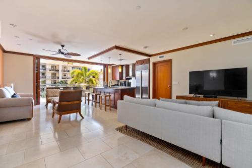 a living room with a couch and a flat screen tv at Beachfront Condo at Beach Villas at Ko Olina Hale Hoaloha by AvantStay in Honokai Hale