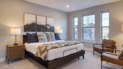 a bedroom with a large bed and a chair at Abigail Drive Year-Round Retreat with Hot Tub Near Park City Adventures Skiing in Heber City
