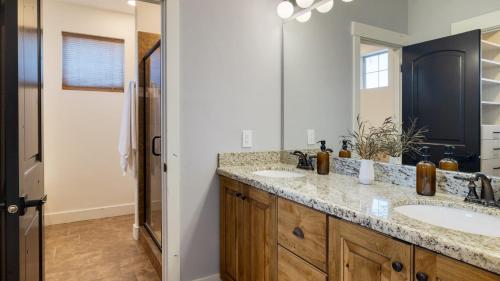 a bathroom with two sinks and a large mirror at Abigail Drive Year-Round Retreat with Hot Tub Near Park City Adventures Skiing in Heber City