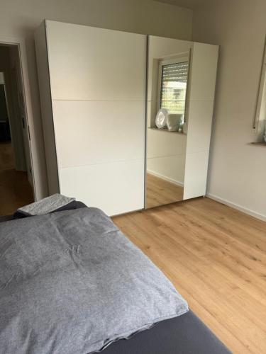 a bedroom with a bed and a large mirror at Deluxe Apartments Messe Flughafen in Leinfelden-Echterdingen