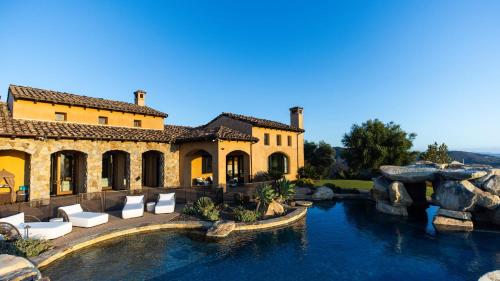 a house with a swimming pool and a water slide at Infinity Pool Theater Pickleball 360 Views Near Lake Poway Sunset Point Estate by AvantStay in Rancho Bernardo