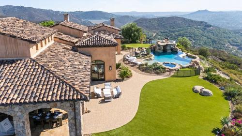 an aerial view of a house with a swimming pool at Infinity Pool Theater Pickleball 360 Views Near Lake Poway Sunset Point Estate by AvantStay in Rancho Bernardo