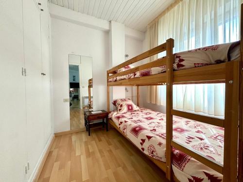 a bedroom with two bunk beds and a mirror at Apartamentos Meritxell Sherpa in Pas de la Casa