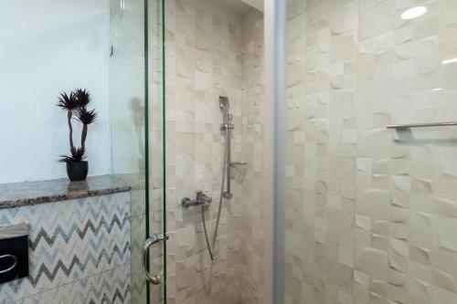 a bathroom with a shower with a glass door at Gold Crest Luxury Serviced Apartments City View DHA Lahore in Lahore
