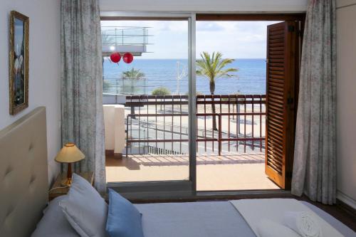 a bedroom with a bed and a view of the ocean at Apartamento PLAYAZUL 4 in Cambrils