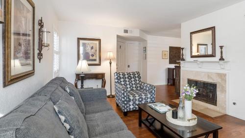 a living room with a couch and a fireplace at Coastal Retreat w Pool Spa BBQ Near Beaches Golf Courses Ritz Pointe Condo by AvantStay in Dana Point