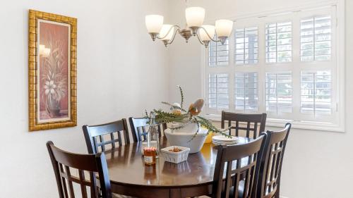 a dining room with a wooden table and chairs at Coastal Retreat w Pool Spa BBQ Near Beaches Golf Courses Ritz Pointe Condo by AvantStay in Dana Point