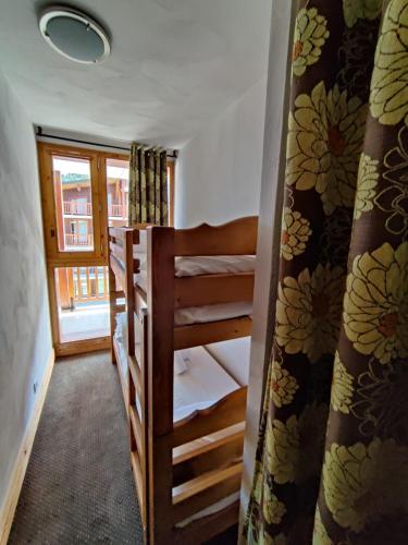 a room with two bunk beds and a window at Chalet des Neiges : La Cime Des Arcs in Arc 2000