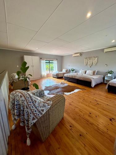 a large room with two beds and a couch at Stella Maris Cabanas in Ponta do Ouro