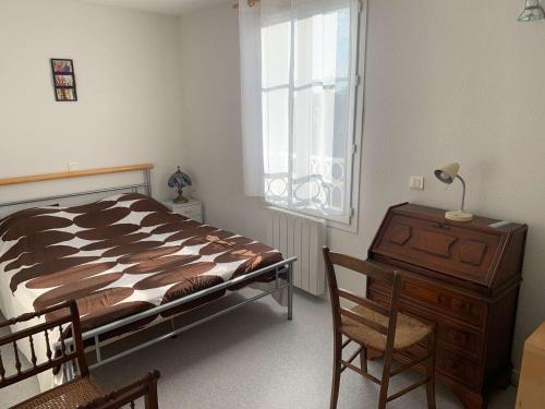 En eller flere senge i et værelse på L’Oasis de la Parée Bretignolles