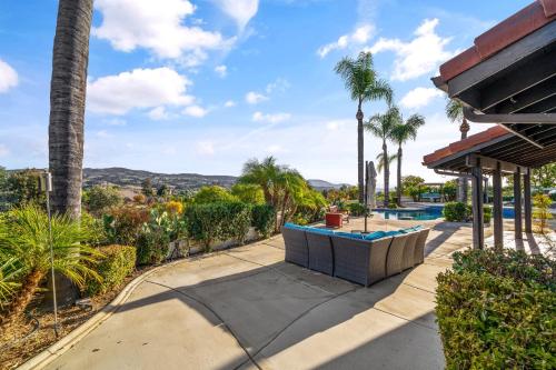 a house with a swimming pool and palm trees at Vineyard Escape - Pool & Views by Allevo Homes in Country Road Estates