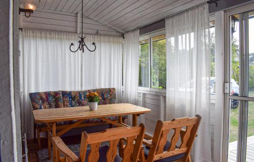 Hällevikにある3 Bedroom Awesome Home In Sölvesborgの木製のテーブルと椅子のあるダイニングルーム