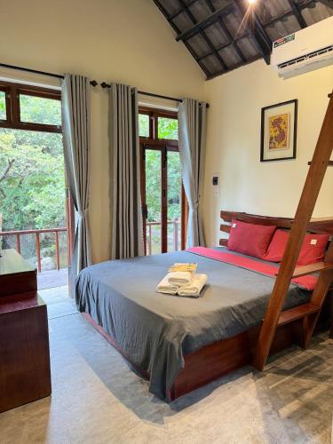 a bedroom with a bed with towels on it at Chez Vous House - Toom Sara in Mang Son