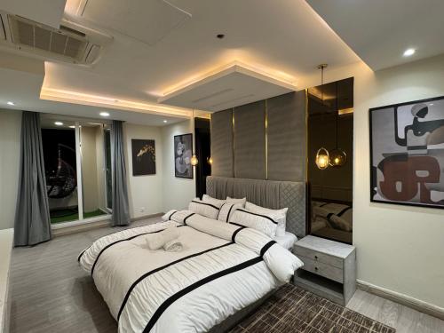 a large bedroom with a large bed in it at Gold Crest Grand Executive Hotel Apartments DHA Lahore in Lahore