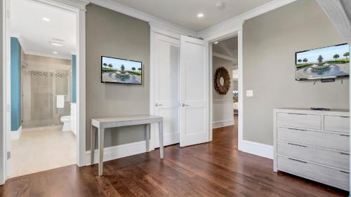 a white bathroom with a vanity and a clock on the wall at 3100 Palm Boulevard by AvantStay Beachfront Ocean Views Private Pool in Isle of Palms