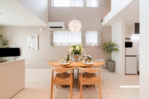 a kitchen and dining room with a table and chairs at Newly opened! Hidden Gem in Ikejiri - Quiet Stylish Minutes to Shibuya in Tokyo